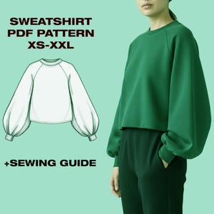 May include: A green sweatshirt with a crew neck and long, voluminous sleeves. The image includes a line drawing of the sweatshirt and text that reads "SWEATSHIRT PDF PATTERN XS-XXL" and "+SEWING GUIDE".