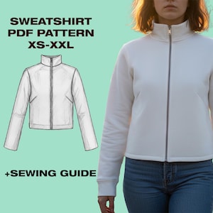 Op de afbeelding: Een witte sweatshirt met ritssluiting en hoge kraag wordt getoond. De afbeelding bevat ook een lijntekening van de sweatshirt en de tekst "SWEATSHIRT PDF PATTERN XS-XXL +SEWING GUIDE". Het model draagt een blauwe spijkerbroek.