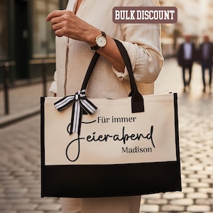 May include: A white ceramic mug with a black handle and the text "But First, Coffee" in a bold, black font. The mug is set against a blurred background, suggesting a cozy setting.