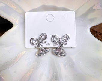 Salturn orb pearl Earrings with bows in pink color