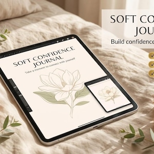 Peut inclure: Une tablette numérique affichant un journal intitulé Soft Confidence Journal avec une illustration florale au trait et le texte 'Take a moment to connect with yourself'. L'écran affiche également le titre et 'Build confidence one page at a time'.