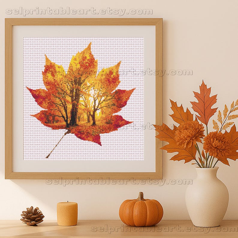 Romantic autumn forest landscape cross stitch inside a maple leaf design - Golden fall leaf embroidery pattern featuring a glowing woodland scene - Nature-inspired autumn decor – maple leaf cross stitch with forest sunlight - Rustic woodland fall embroidery, perfect for cozy seasonal wall art - Detailed maple leaf cross stitch pattern with a warm, romantic autumn theme