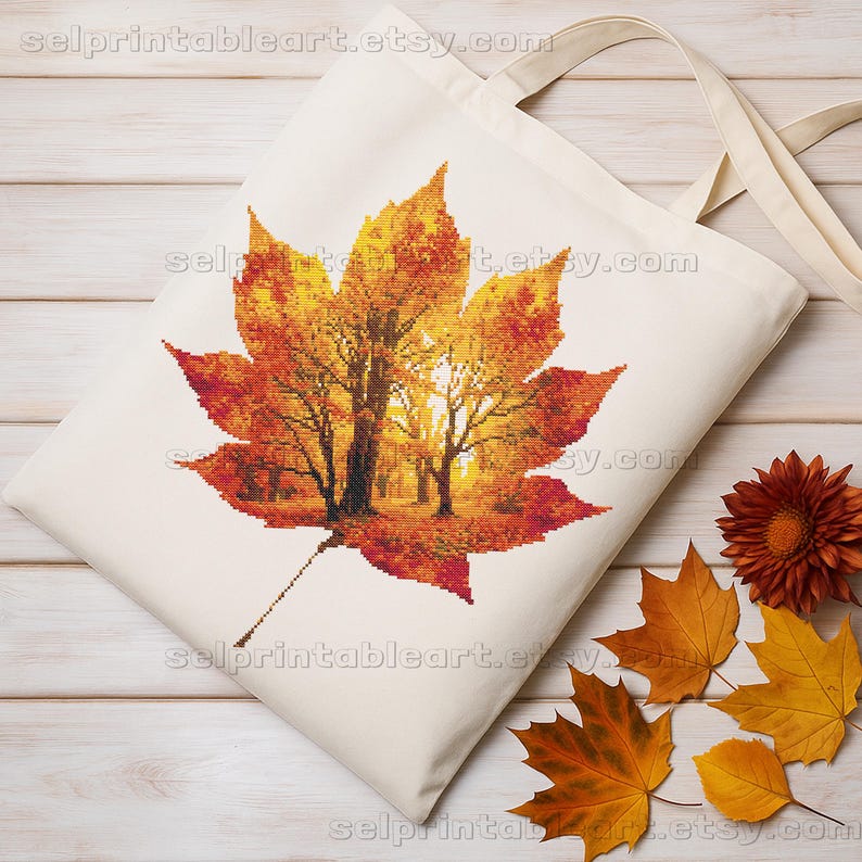 Romantic autumn forest landscape cross stitch inside a maple leaf design - Golden fall leaf embroidery pattern featuring a glowing woodland scene - Nature-inspired autumn decor – maple leaf cross stitch with forest sunlight - Rustic woodland fall embroidery, perfect for cozy seasonal wall art - Detailed maple leaf cross stitch pattern with a warm, romantic autumn theme