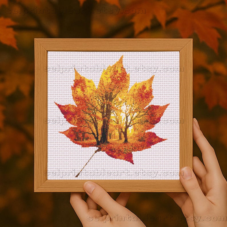 Romantic autumn forest landscape cross stitch inside a maple leaf design - Golden fall leaf embroidery pattern featuring a glowing woodland scene - Nature-inspired autumn decor – maple leaf cross stitch with forest sunlight - Rustic woodland fall embroidery, perfect for cozy seasonal wall art - Detailed maple leaf cross stitch pattern with a warm, romantic autumn theme