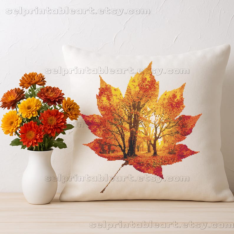 Romantic autumn forest landscape cross stitch inside a maple leaf design - Golden fall leaf embroidery pattern featuring a glowing woodland scene - Nature-inspired autumn decor – maple leaf cross stitch with forest sunlight - Rustic woodland fall embroidery, perfect for cozy seasonal wall art - Detailed maple leaf cross stitch pattern with a warm, romantic autumn theme