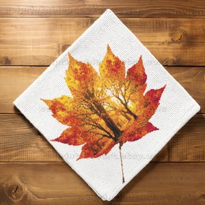 Romantic autumn forest landscape cross stitch inside a maple leaf design - Golden fall leaf embroidery pattern featuring a glowing woodland scene - Nature-inspired autumn decor – maple leaf cross stitch with forest sunlight - Rustic woodland fall embroidery, perfect for cozy seasonal wall art - Detailed maple leaf cross stitch pattern with a warm, romantic autumn theme