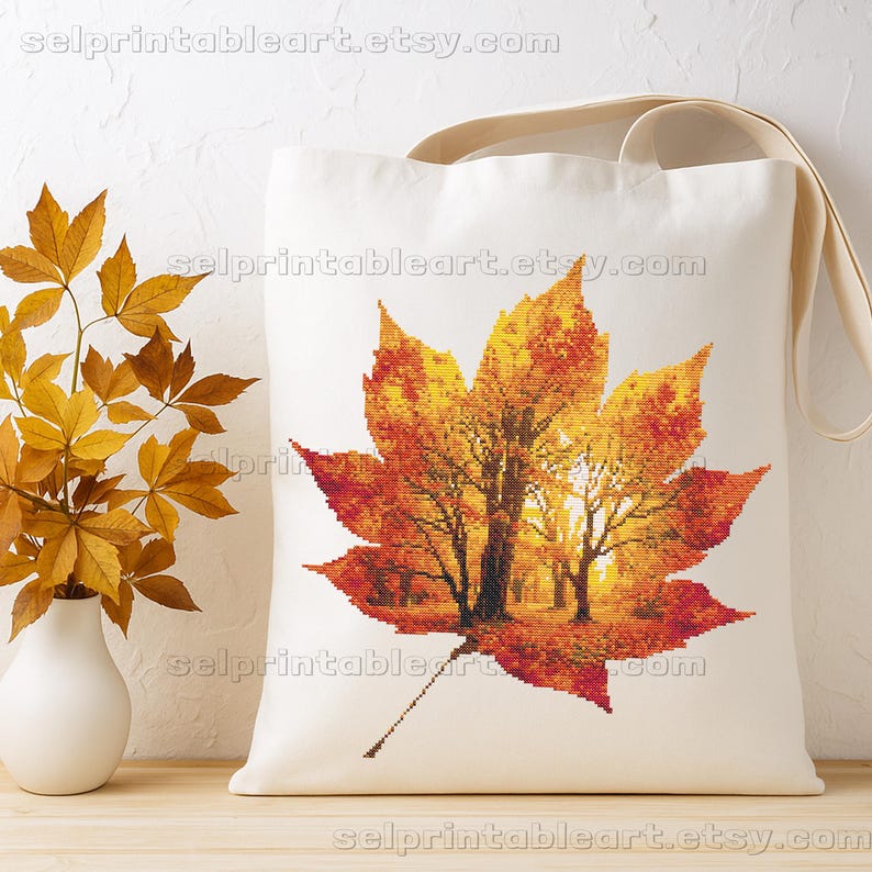 Romantic autumn forest landscape cross stitch inside a maple leaf design - Golden fall leaf embroidery pattern featuring a glowing woodland scene - Nature-inspired autumn decor – maple leaf cross stitch with forest sunlight - Rustic woodland fall embroidery, perfect for cozy seasonal wall art - Detailed maple leaf cross stitch pattern with a warm, romantic autumn theme