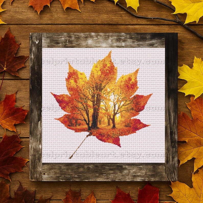 Romantic autumn forest landscape cross stitch inside a maple leaf design - Golden fall leaf embroidery pattern featuring a glowing woodland scene - Nature-inspired autumn decor – maple leaf cross stitch with forest sunlight - Rustic woodland fall embroidery, perfect for cozy seasonal wall art - Detailed maple leaf cross stitch pattern with a warm, romantic autumn theme