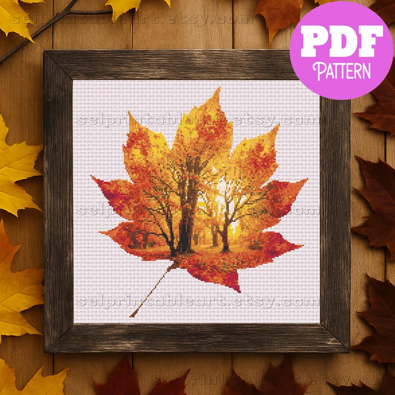 Romantic autumn forest landscape cross stitch inside a maple leaf design - Golden fall leaf embroidery pattern featuring a glowing woodland scene - Nature-inspired autumn decor – maple leaf cross stitch with forest sunlight - Rustic woodland fall embroidery, perfect for cozy seasonal wall art - Detailed maple leaf cross stitch pattern with a warm, romantic autumn theme