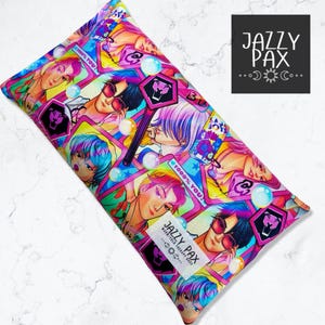 May include: Rectangular Jazzy Pax warm/cold therapy bag with a colorful anime-style print. The design features multiple illustrations of anime characters, bubbles, and geometric shapes in pink, blue, yellow, and purple. The Jazzy Pax logo is visible.