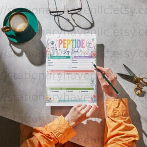 May include: A Peptide Log Book paper sheet with colorful headers and floral accents, featuring sections for tracking medication details, dosage, and notes. The page includes illustrations of vials and syringes, with text reading Peptide Log Book.