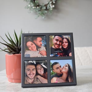 May include: A dark gray square photo frame with four individual photo slots. Each slot contains a color photograph of a couple. A potted succulent and a decorative wreath are in the background.
