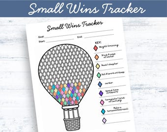May include: A Small Wins Tracker printable sheet featuring a hot air balloon graphic with a diamond-patterned canopy. The tracker includes a key with colored diamonds for tracking habits like weight training, water intake, sleep, and laundry tasks.