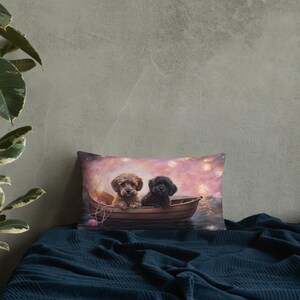 May include: A throw pillow with a painting of two small dogs in a boat on a pink and purple background with white lights.