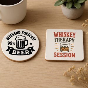 May include: Two drink coasters with cork backing. One is round with "Weekend Forecast 99% Beer" text and a beer mug graphic. The other is square with "Whiskey Therapy Session" text and a whiskey glass graphic.
