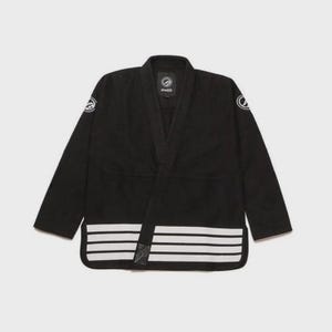 May include: Black martial arts uniform with white stripes along the bottom and white circular logos on the sleeves. The uniform has a wrap-around closure and a collar. The brand name is visible on the collar.