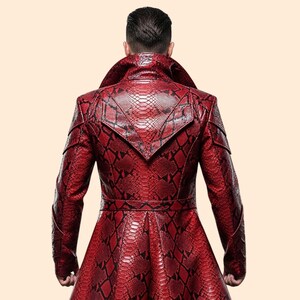 May include: A red snakeskin-patterned coat with a wide collar and a belt. The coat has a long, flowing design and is made of a textured material. The back of the coat is visible, showcasing the intricate pattern and tailoring.