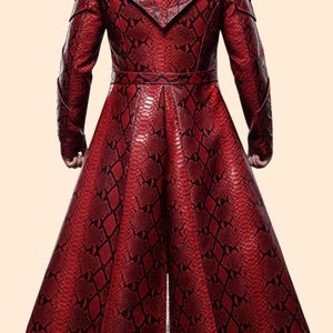 May include: A long, red coat with a snakeskin pattern. The coat features a notched collar, long sleeves, and a belted waist. The fabric has a textured appearance with black accents, creating a striking visual effect. The coat's design suggests a dramatic, high-fashion aesthetic.