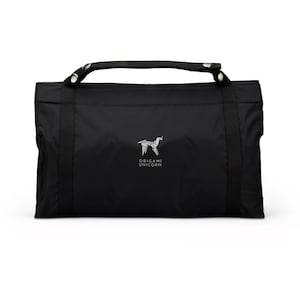 May include: A black travel bag with a top handle and the text "Origami Unicorn" printed on the front.
