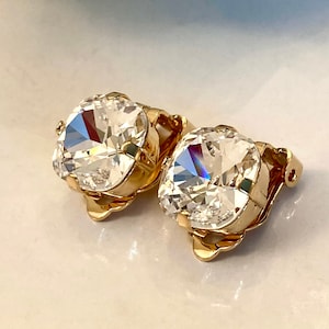 May include: A pair of gold-tone clip-on earrings with clear round stones.