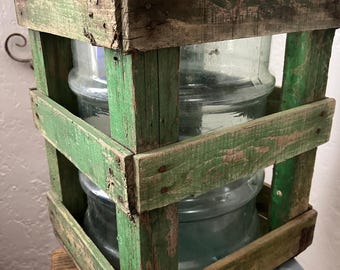 Vintage wooden crate with plastic 5 gallon water bottle