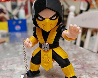 May include: A stylized Scorpion figurine from Mortal Kombat wearing a black and yellow ninja outfit with a hood, mask, and skull belt buckle. The character holds a silver kunai spear attached to a chain, with the text NO AMS visible above.