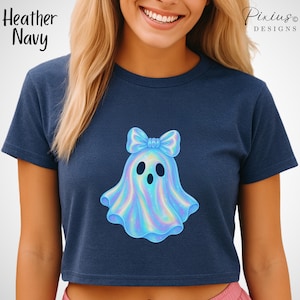 Puede incluir: Top corto azul marino con un diseño de fantasma y un lazo. El fantasma es azul claro con reflejos iridiscentes. El texto "Heather Navy" está en la parte superior izquierda. La marca "Pixius Designs" está en la parte superior derecha.