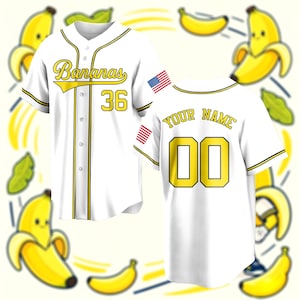 May include: A white baseball jersey with yellow and black trim. The front features the text Bananas and the number 36 in yellow with black outlines. The back displays the text YOUR NAME and the number 00. An American flag patch is on the sleeve.