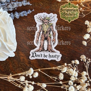 May include: A sticker featuring a tree-like figure with a beard and leafy crown, with the words "Don't be hasty" in a gothic font. The sticker is surrounded by dried flowers and lavender.