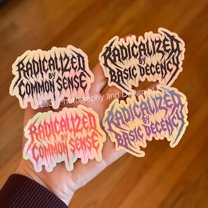 May include: Four holographic stickers with the phrases "RADICALIZED BY COMMON SENSE" and "RADICALIZED BY BASIC DECENCY" in a gothic font. The stickers have a pearlescent sheen and are held in a hand.