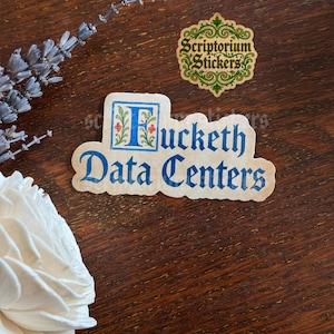 May include: A die-cut sticker featuring the text "Fucketh Data Centers" in a blue gothic-style font. The letter F is enclosed in a decorative square with floral details. A smaller, separate sticker above displays the text "Scriptorium Stickers".
