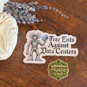 May include: A die-cut sticker featuring a brown tree-like creature holding a gray stone, with the black text Tree Ents Against Data Centers. Below it is a smaller, circular, ornate green sticker with the text Scriptorium Stickers in black.