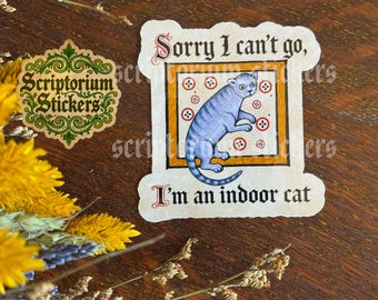 May include: A die-cut sticker featuring a blue cat inside a square frame with red button motifs, accompanied by the text "Sorry I can't go, I'm an indoor cat" in a black gothic font. A separate logo sticker reads "Scriptorium Stickers" in green.