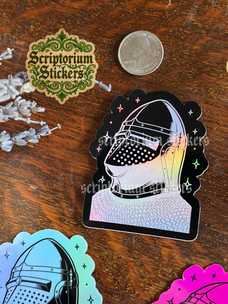 May include: A collection of stickers featuring a knight's helmet, a logo with the text "Scriptorium Stickers", and a quarter. The knight's helmet sticker has a black background with a holographic design. The logo is green and gold.