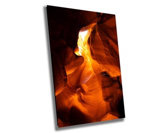 May include: A narrow canyon with smooth, orange-red rock walls. Sunlight streams through a gap at the top, illuminating the canyon's interior.