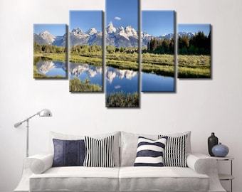 May include: A five-piece canvas print set featuring a scenic landscape with snow-capped mountains reflected in a still lake. The mountains are a light blue and white, the lake is a deep blue, and the surrounding foliage is a vibrant green.