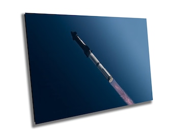 May include: A rocket ship with a plume of smoke trailing behind it, against a dark blue sky.