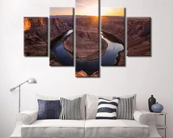 May include: A five-piece canvas print set featuring a panoramic view of a horseshoe bend in a desert landscape. The bend is formed by a river winding through the canyon, with the sun setting in the background.