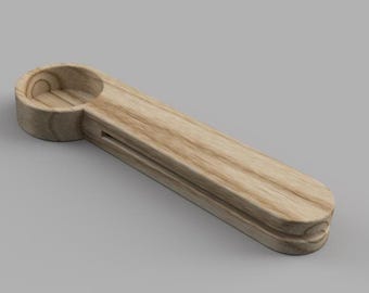 May include: A wooden spoon with a scoop on one end and a handle on the other. The spoon is made of light brown wood with a natural grain pattern.