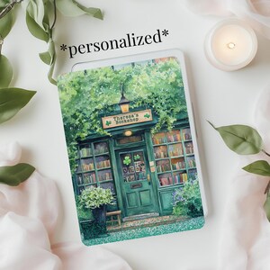 May include: A green storefront with a sign that reads "Theresa's Bookshop" and a green door with a shamrock design. The storefront is surrounded by lush green foliage.