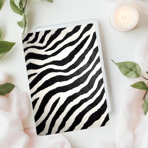 May include: A black and white zebra print design on a white background. The design is a repeating pattern of black and white stripes.