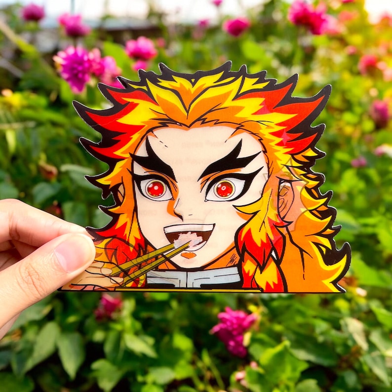 May include: A sticker featuring a cartoon character with fiery orange hair, red eyes, and a mischievous grin. The character is holding chopsticks and eating a bowl of noodles.
