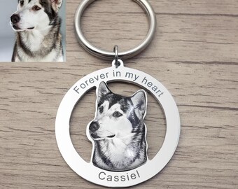 May include: Silver keyring with a photo of a husky dog in a circle. The circle has the text "Forever in my heart" and the name "Cassiel" engraved below the photo.
