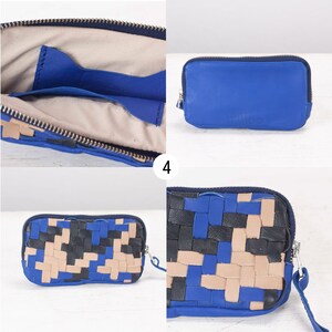 May include: A blue leather zippered pouch with a woven leather design. The pouch is open to show the inside lining. The pouch is on a white surface.