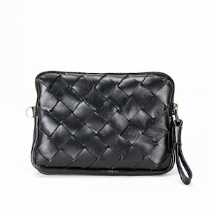 May include: A black woven leather clutch with a zipper closure and a small strap.