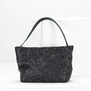 May include: A black leather handbag with a blue stitched pattern and a single top handle.