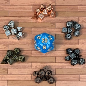 May include: A collection of polyhedral dice in various colors and materials, including silver, copper, bronze, and blue. The dice are arranged on a wooden surface, showcasing different shapes and sizes for tabletop gaming.