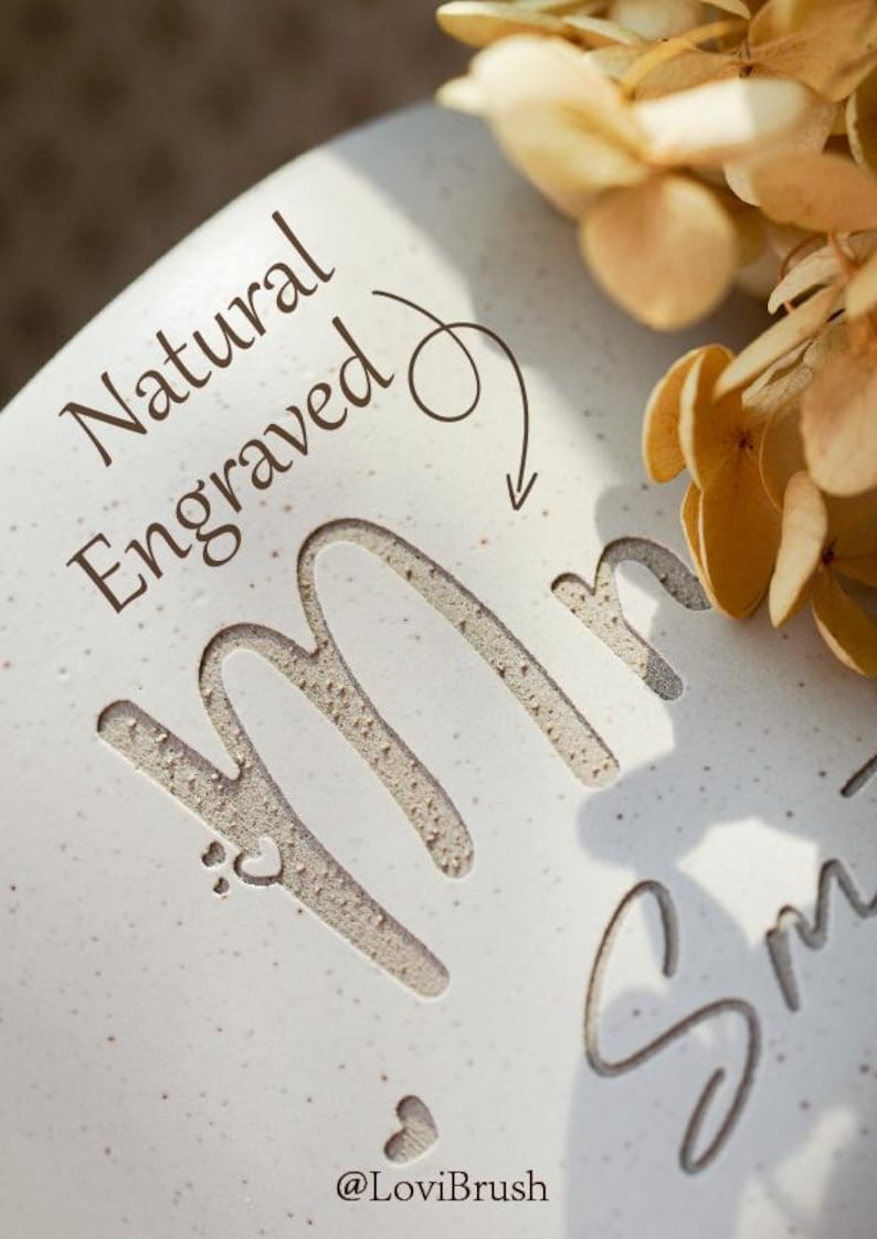 May include: A close-up of a white ceramic surface with the engraved word "Mr" and the last name "Smith". The words "Natural Engraved" are above the name, with a heart symbol. The Etsy shop name "@LoviBrush" is at the bottom.