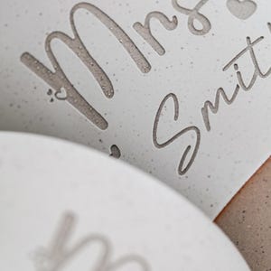 May include: White ceramic mug with the text "Mrs. Smith" in a cursive font with a small heart symbol.
