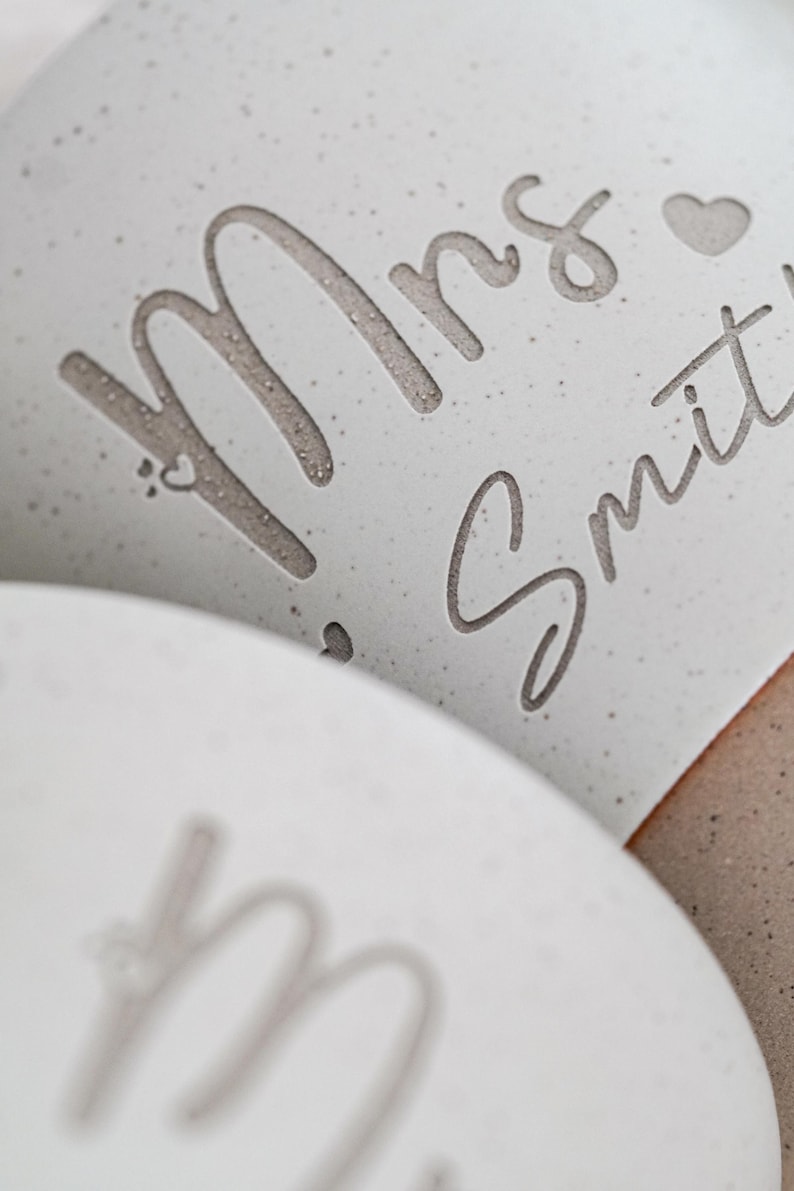 May include: White ceramic mug with the text "Mrs. Smith" in a cursive font with a small heart symbol.